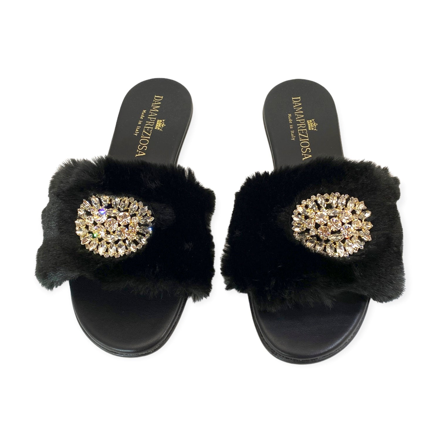 Made in Italy. Black vegan faux fur and vegan leather embellished with white crystals. Elegant padded insoles in soft black vegan leather to add the comfort you deserve. 2 cm. heel covered in black vegan leather. Damapreziosa logo engraved on soles and insoles. Glittery sole. PETA approved vegan product, made with non-leather materials following our cruelty-free ethics. Plastic-free, recycled paper boxes and packaging, and organic cotton dust bag.