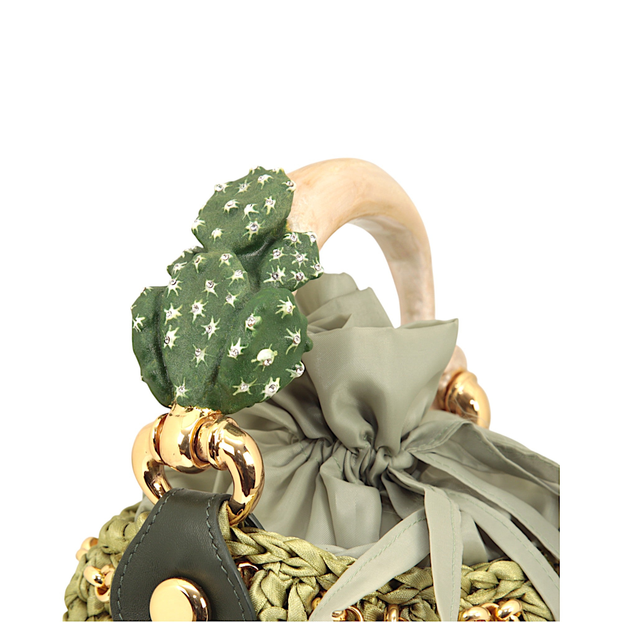 Bucket bag with cactus sculpture handle in hand-painted enamel and crocheted satin body
Made in Italy bucket bag with gold-tone cactus handle and removable chain strap
Artisanal bucket bag with sculptural cactus handle by Inga Sirmione