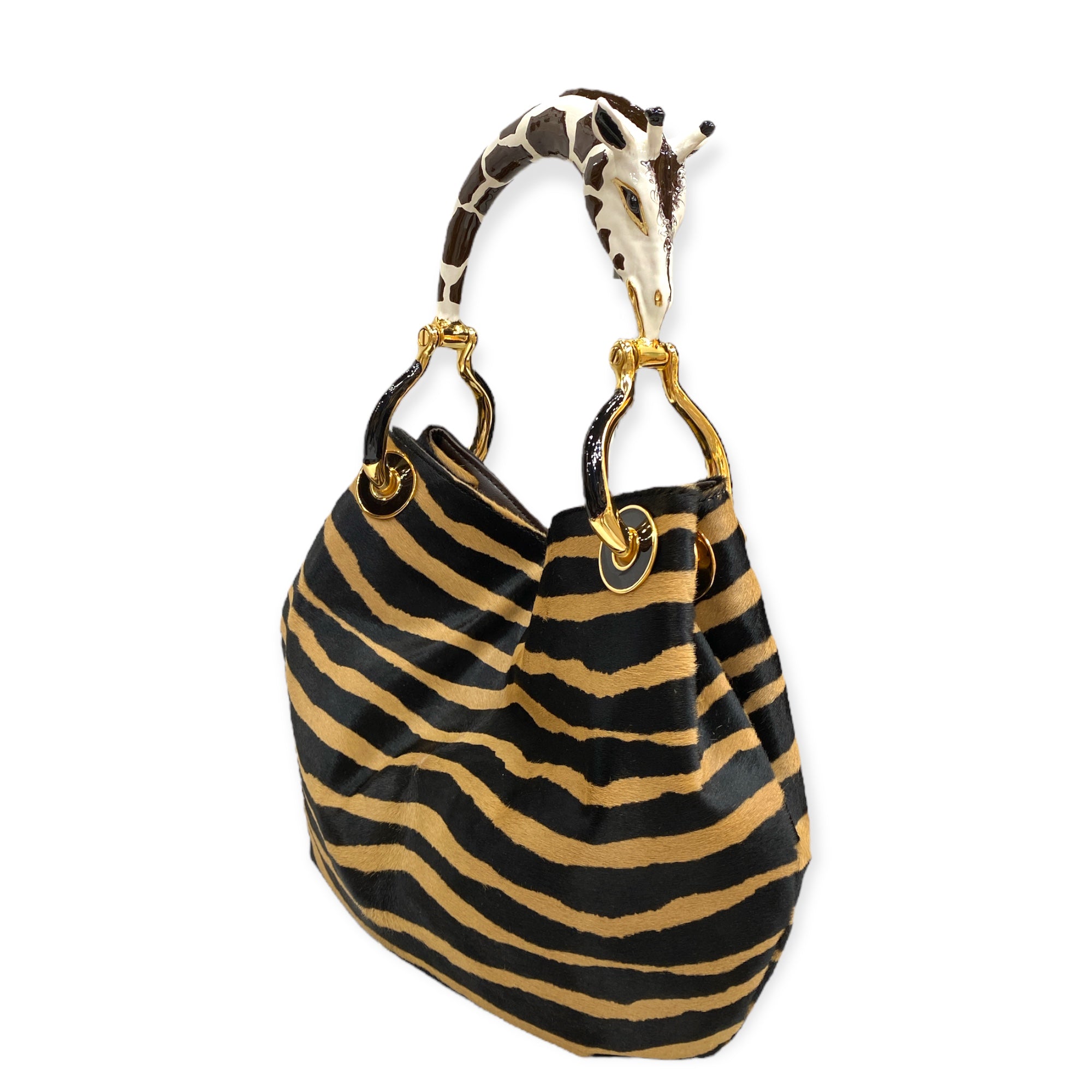 GIRAFFE SMALL BAG WITH PONY-HAIR PRINT   LUXURY HANDBAGS COLLECTION Creart2 Made in Italy Precious handbag made in Italy with fine accessories made in polychrome enamels and exclusive hides, every bag is the result of an accurate handcraft manufacture that makes it unique. The "sculpture" handle is made of metal with 24 Kt Gold Plated parts and the enamel is…